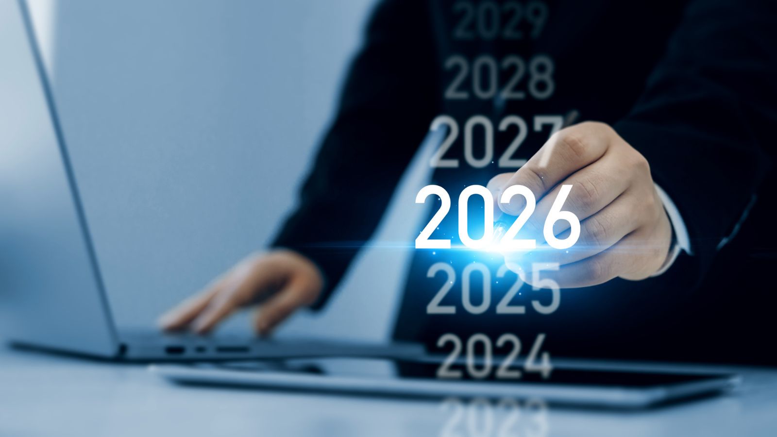 Professional in a suit interacting with a digital interface highlighting the year 2026 for business growth.