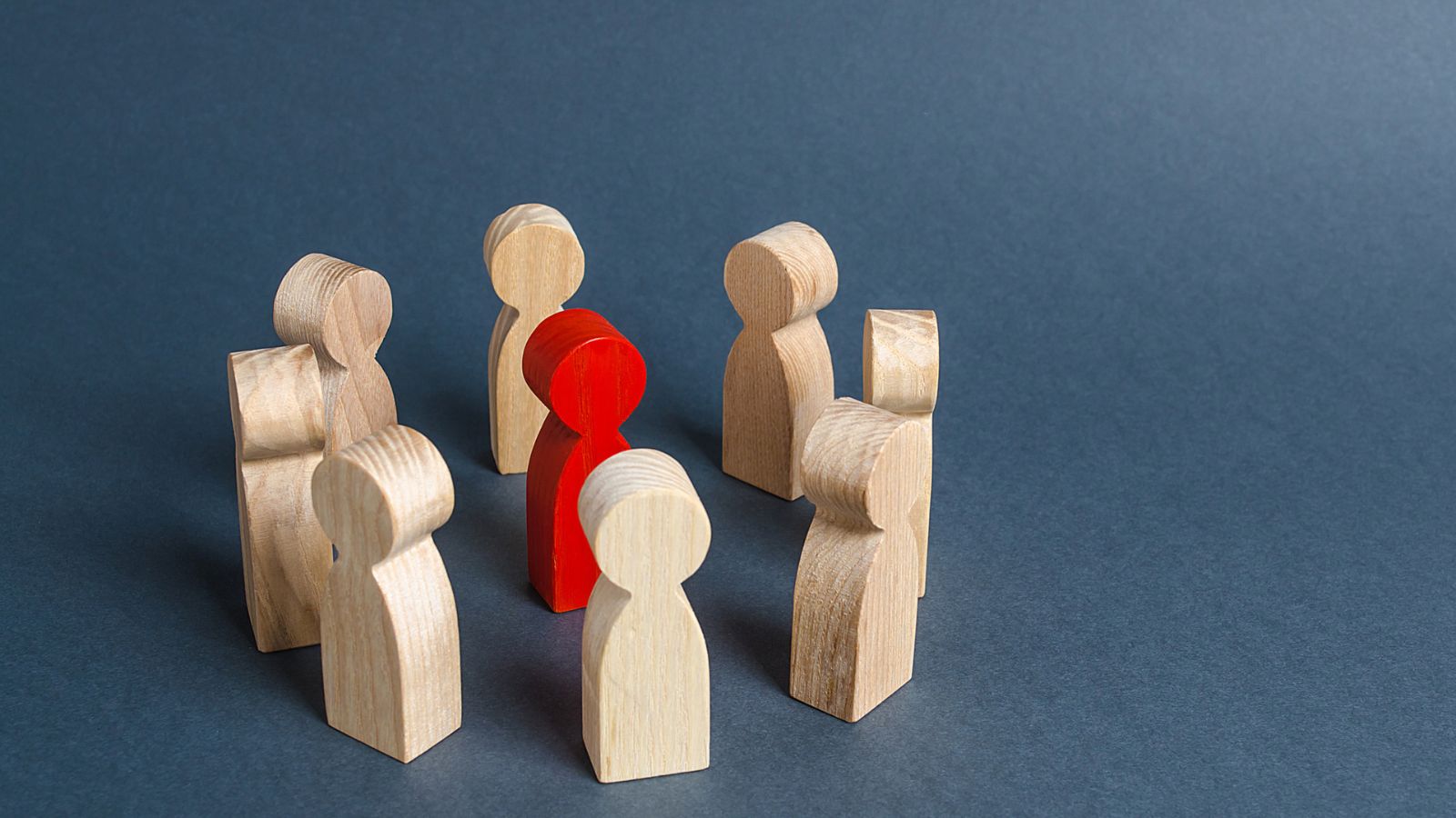 Red figure among white figures illustrating human-in-the-loop oversight in AI workflows.